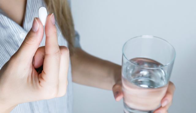 woman taking pill